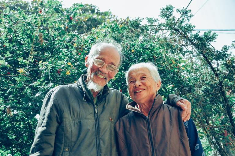 senior asian couple outside smiling